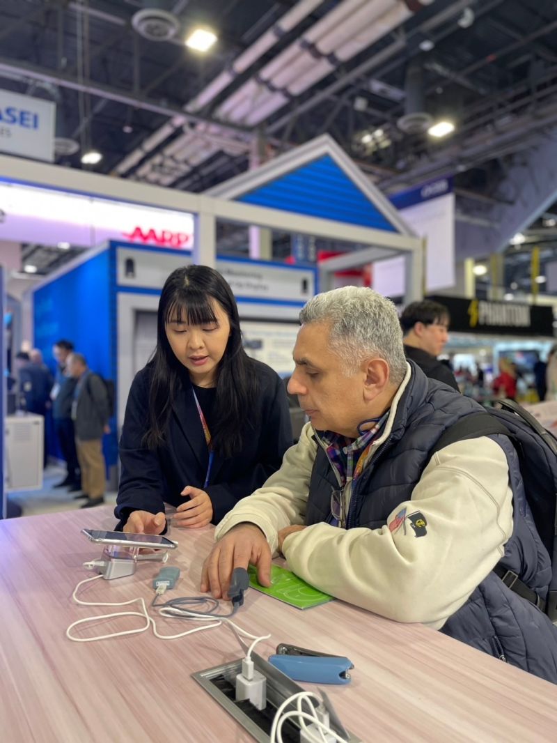 Visitors trying the RadiHeart fingertip sensor at the booth