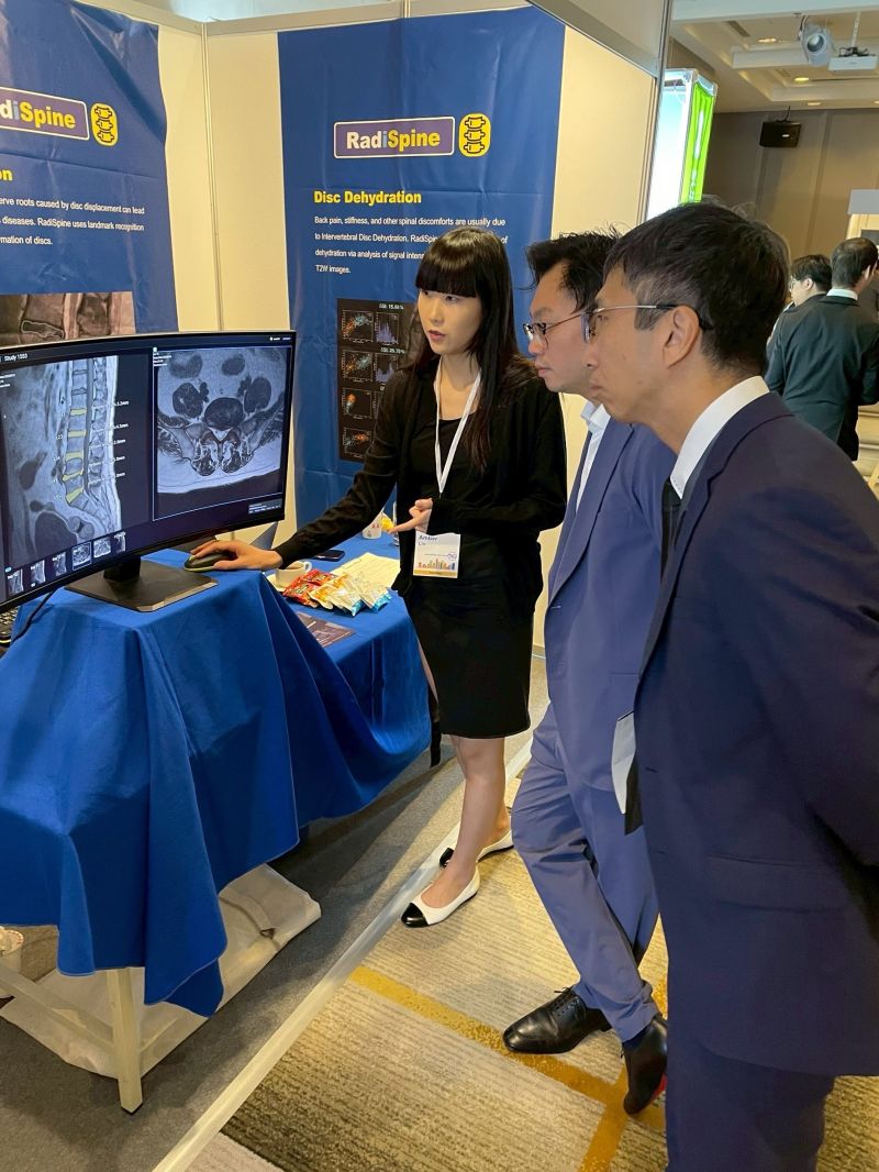 A RadiRad team member demonstrates RadiSpine to attendees